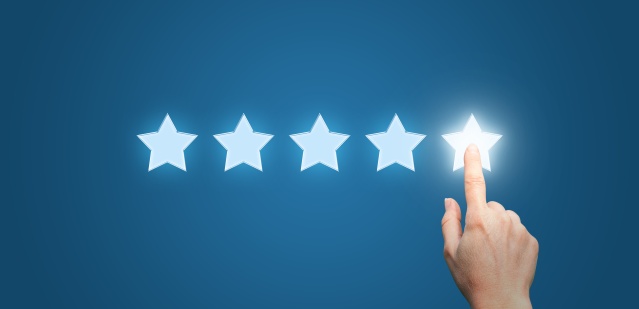 Businesswoman pointing five star to increase