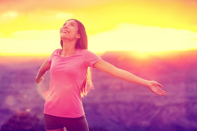 Free happy woman enjoying nature sunset. Freedom, happiness and enjoyment concept of young multiracial Asian chinese girl with open arms in hope and success with Grand Canyon mountains, USA.